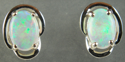 Crystal opal earstuds in 18ct white gold - 0.60ct pair of crystal opal oval cabochons set in 18ct white gold. Earstuds are 8x10mm.