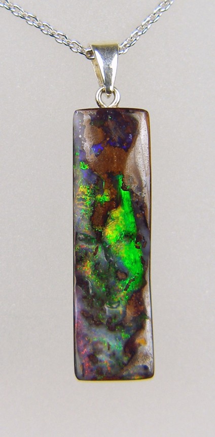 14.52ct slim rectangular boulder opal pendant in silver - Boulder opal from Queensland, Australia 9 x 29mm, vivid green flashes, with silver bail and suspended from adjustable silver chain