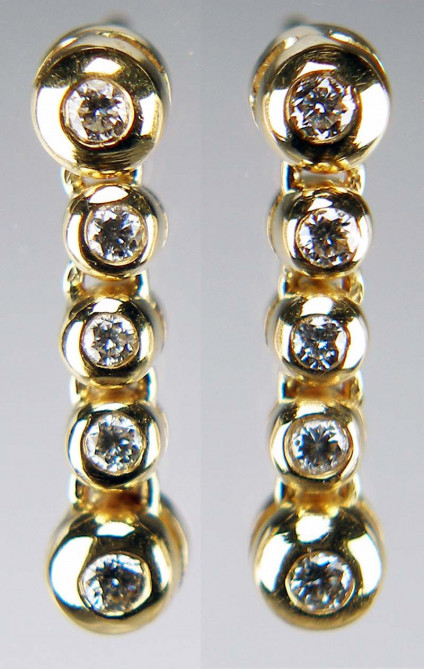 Diamond rubover drop earrings in 14ct yellow gold - 0.25ct total diamond weight of round brilliant cut diamonds rubover set in 14ct yellow gold. The earrings are 16mm long. These earrings are included in our 20 year anniversary sale and now cost £387.50