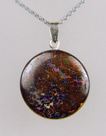 22.62ct round boulder opal pendant in silver - 22mm round boulder opal pendant with vivid colour flashes in orange and red, with silver bail on adjustable silver chain