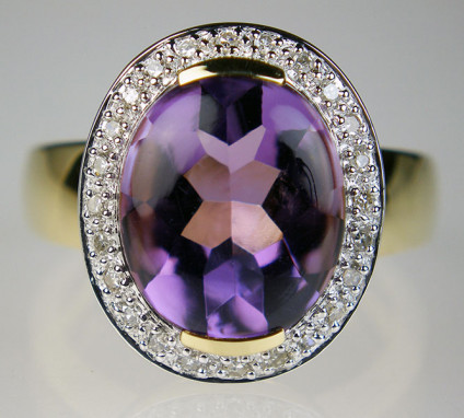 Amethyst cabochon & diamond halo ring in 9ct yellow gold - 4.12ct oval cabochon top, faceted back amethyst with a delicate diamond set halo, ring in 9ct yellow gold