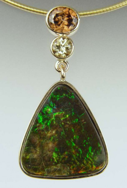 Ammolite, zircon & topaz pendant - 9.95ct ammolite (opalised ammonite shell) from Alberta, Canada, set with 1.34ct brown zircon from Myanmar, and 0.53ct round yellow topaz, all in 9ct yellow gold