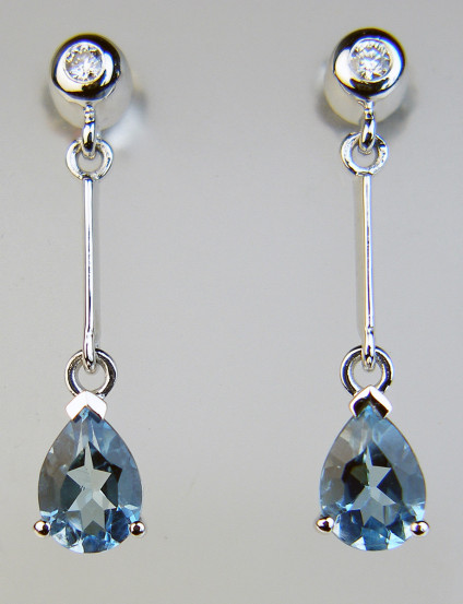 Aquamarine & diamond eardrops in white gold - 1.09ct pair of pear cut aquamarines set with 0.065ct of round brilliant cut white diamonds in 9ct white gold. The eardrops are 25mm long.