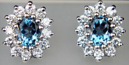 Aquamarine & diamond earstuds in 18ct white gold - 1ct pair of top colour blue aquamarines, surrounded by halos of round brilliant cut diamonds totalling 0.5ct, mounted in 18ct white gold as earstuds. These pre-loved earrings have been carefully inspected by our gemmologist and goldsmith and come with a six month Just Gems warranty.