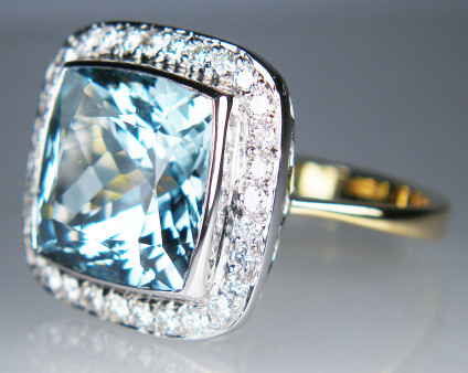 Aquamarine & diamond ring - 7.08ct cushion cut aquamarine surrounded by 0.50ct halo of round brilliant cut diamonds in 18ct white & yellow gold