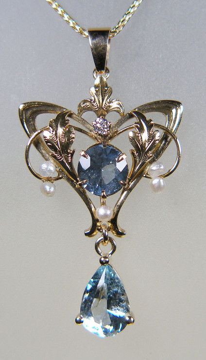 Art Nouveau Krementz Aquamarine Pendant - Exquisite Krementz manufactured 14ct yellow gold pendant set with 2.2ct aquamarines, a tiny diamond & seed pearls, suspended from a 20" 14ct yellow gold chain. Pendant is available for separate sale at £599, chain is £270. The pendant is pre-owned, it has been carefully checked by both our gemmologist and goldsmith, and is accompanied by a six month warranty.
