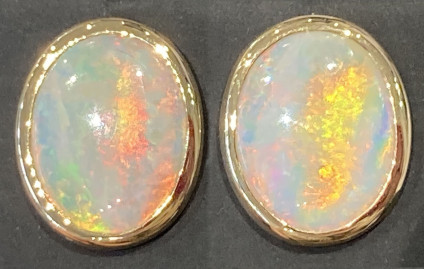 Solid opal earstuds in 18ct yellow gold - Exceptional quality, 8.5ct large oval opal cabochon pair mounted in 18ct yellow gold. The opal is Mintabie white opal with fantastic play of colour in orange, green, yellow and red. The earstuds are 20x15mm.