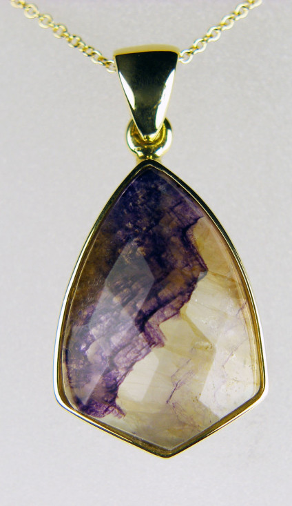 Blue John pendant in 18ct yellow gold - Faceted Blue John pendant in 18ct yellow gold on delicate 20" fine trace chain. Blue John is a variety of fluorspar found only in Castleton in Derbyshire.