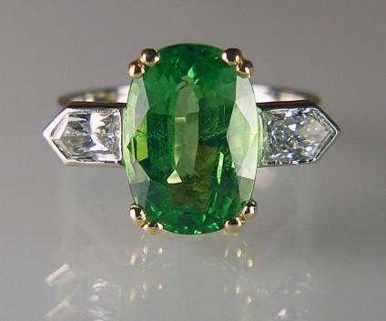 Tsavorite & diamond ring - 5.66ct cushion cut tsavorite garnet set with 0.70ct bullet cut diamond pair in G colour VS2 clarity and mounted in an 18ct white and yellow gold ring