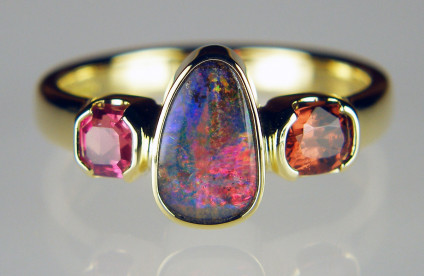Boulder opal, spinel & ruby birthstone ring - Striking ring made with family birthstones and set with a Queensland boulder opal (October), a 0.48ct cushion cut brown Burmese spinel (August) and a 0.42ct ruby octahedron (July), all mounted in 18ct yellow gold