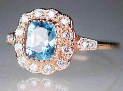 Blue topaz and diamond rng in 9ct rose gold - Vintage style cushion cut blue topaz ring with diamond halo and diamond set shoulders in 9ct rose gold