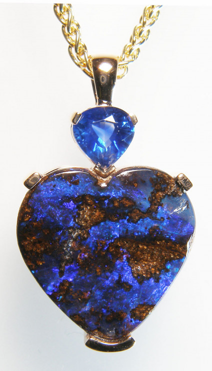 Boulder opal & sapphire heart pendant in 18ct rose gold - The loveliest royal blue heart shaped sapphire weighing 0.7ct and set above a 7.36ct heart cut boulder opal from Queensland, Australia. The pendant is mounted in 18ct rose gold. The chain is not included in the price.