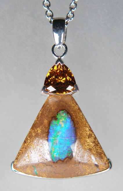 Boulder opal & Mali garnet pendant in silver - 9.17ct keystone shaped boulder opal from Queensland, Australia, set with a 0.65ct trillion cut Mali garnet in silver pendant. The pendant measures 18x27mm. The chain is available for separate purchase.