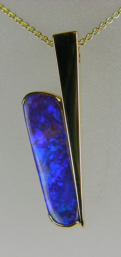 Boulder opal pendant in 18ct yellow gold - 4.82ct brilliant purple-blue boulder opal set in a handmade angular 18ct yellow gold pendant mount and suspended from a 21" adjustable fine trace chain in 18ct yellow gold