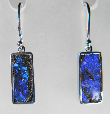 Boulder opal eardrops in silver - 9.26ct pair of rectangular boulder opals from Queensland, Australia, rubover set in silver and suspended from simple silver hooks. The opals measure 8x18mm.
