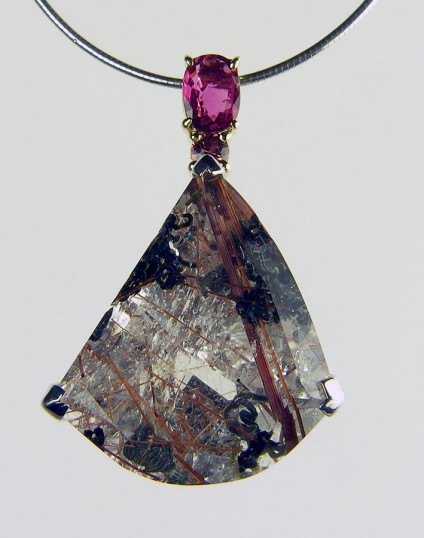 Ruby, sapphire & quartz with brookite inclusions pendant - 0.81ct oval ruby set with 0.17ct brown sapphire and 34.73ct freeform quartz with brookite inclusions set in 18ct white & yellow gold