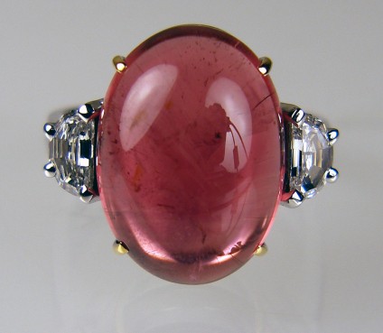 Cabochon tourmaline ring - Superb 15.50ct cabochon cut red tourmaline set with 0.55ct pair of G colour VS1 clarity half moon cut diamonds, mounted in 18ct white & yellow gold.