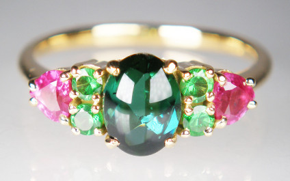 Cabochon tourmaline,pink sapphire & tsavorite garnet ring in 18ct yellow gold - 1.4ct cabochon tourmaline flanked by 0.31ct of round brilliant cut green tsavorite garnets and a 0.67ct pair of heart cut pink sapphires set in 18ct yellow gold ring