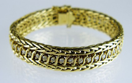 14ct gold and diamond bracelet - Beautiful woven linked 14ct yellow gold bracelet. The bracelet is 12mm wide, 176mm long and 3.5mm deep. It is set with 1.5ct of 2mm round brilliant cut diamonds in I colour VS 2 clarity. Bracelet weighs 43g. This item is secondhand.