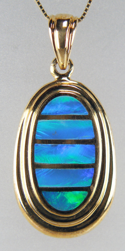 Doublet opal pendant in 14ct yellow gold - Gorgeous oval drop pendant with inlaid doublet opal in 14ct yellow gold. Pendant measures 13 x 29mm. Chain not included.