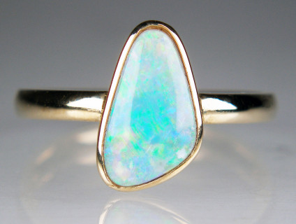 Crystal opal ring in 9ct yellow gold - Beautiful green and bright blue crystal opal rubover set in 9ct yellow gold ring. Finger size M. Opal measures 7 x 12mm.