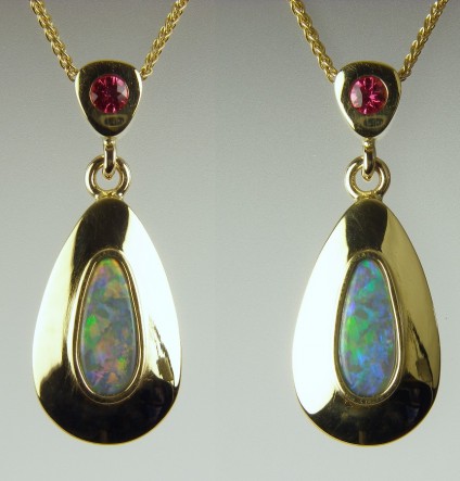 Opal & spinel pendant - Vibrant black opal pear cabochon, 0.5ct, set with 3mm round red spinel in 18ct yellow gold.
Two views of the same pendant, showing how the appearance of wonderful opal can alter with orientation.