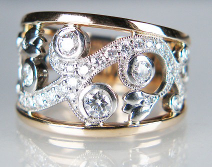 Floral ring with diamonds in 18ct white & rose gold - Beautiful, ornate ring set with 0.88ct of round brilliant cut diamonds (we only sell natural diamonds at Just Gems) set in 18ct white and rose gold. Ring is size P1/2. This ring is pre-loved and has been rigorously checked by our gemmologist and jeweller. It is included in our 20 year anniversary sale and is now discounted by 50%. It costs £1439.