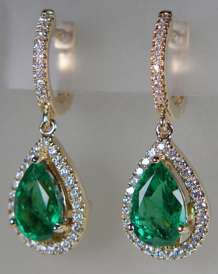Emerald & diamond eardrops n 14ct yellow gold - 3.53ct pair of pear cut Colombian emeralds of the highest quality, surrounded by 0.75ct of round brilliant cut diamonds and mounted as eardrops in 14ct yellow gold. The earrings are 28mm long and 10mm wide,