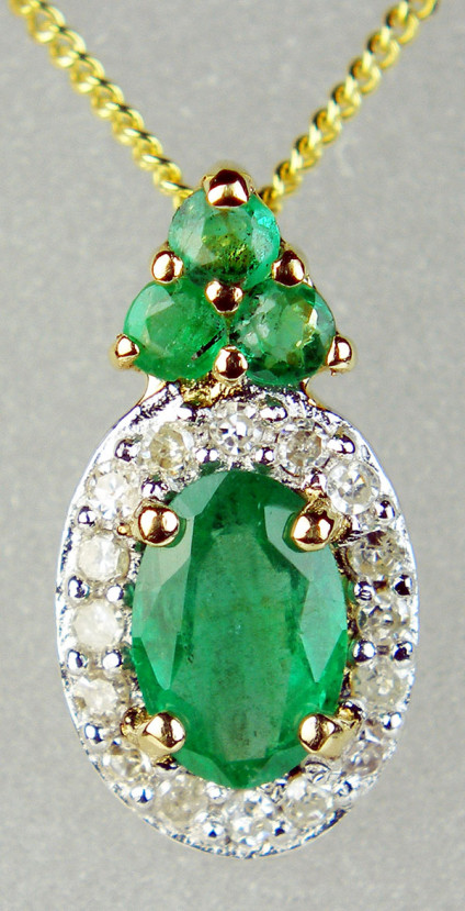 Emerald oval halo pendant in 9ct yellow gold - 0.52ct emerald oval set with 0.08ct diamonds in 9ct yellow gold and suspended from an 18" 9ct yellow gold chain