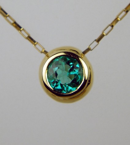 Round emerald pendant - simple rubover set Colombian emerald 0.57ct in 18ct yellow gold on delicate 18ct yellow gold chain