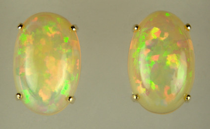 Ethiopian opal stud earrings - 4.79ct oval cabochon Ethiopian opal pair set in 18ct yellow gold as subtly vibrant earstuds