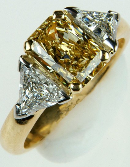 Yellow & white diamond ring in platinum & yellow gold - 1.64ct fancy yellow radiant cut diamond with GIA report, flanked by a matched pair of G/H colour VS2-SI1 clarity, trillion cut white diamonds totalling 0.86ct in weight.  The yellow diamond is set in 18ct yellow gold, the white diamonds in platinum.

