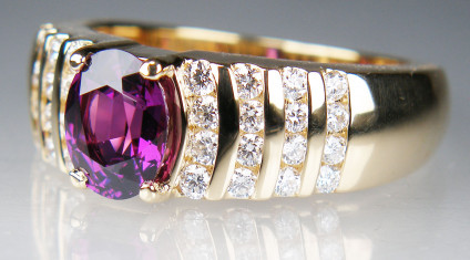 Purple rhodolite garnet & diamond ring in 18ct yellow gold - Dramatic and spectacular ring with a 2.16ct oval purple rhodolite garnet claw set in a heavy 18ct yellow gold mount with 0.9ct of channel set diamonds in F colour VS clarity. This ring weighs 18g and is a size W.