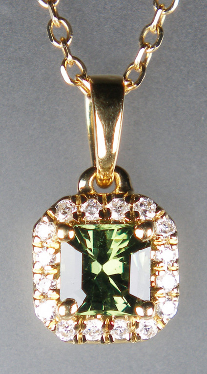 Green sapphire & diamond pendant in 18ct yellow gold - Dainty pendant set with 0.31ct Asscher cut natural green sapphire surrounded by 0.07ct of round brilliant cut diamonds. All set in 18ct yellow gold and suspended from a 16" 18ct yellow gold chain. Pendant is 12mm long. Pendant is £395 and chain is £120.
