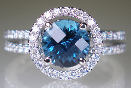 Indicolite & diamond ring in 18ct white gold - 1.66ct round harlequin cut indicolite (blue tourmaline) surrounded by a halo of white diamonds, in a beautiful ring with diamond set shoulders, total diamond weight 0.87ct.