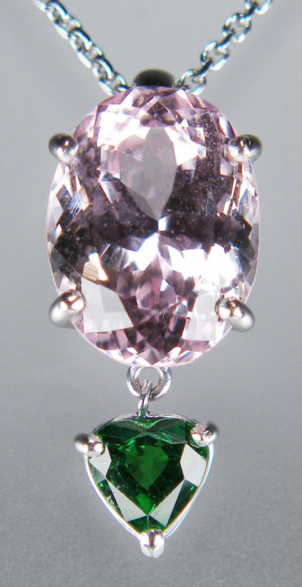 Kunzite & tsavorite garnet pendnat in 18ct white gold - 5.95ct oval kunzite with 0.85ct heart cut tsavorite garnet, both gems claw set in 18ct white gold pendant with chain running behind. Price includes chain. Pendant is 23mm long