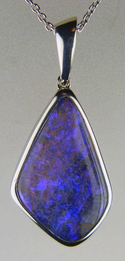 Boulder opal pendant in silver - Beautiful luminous lilac boulder opal in silver suspended from a silver chain. Pendant is 38x18mm. Boulder opal comes from Queensland, Australia.