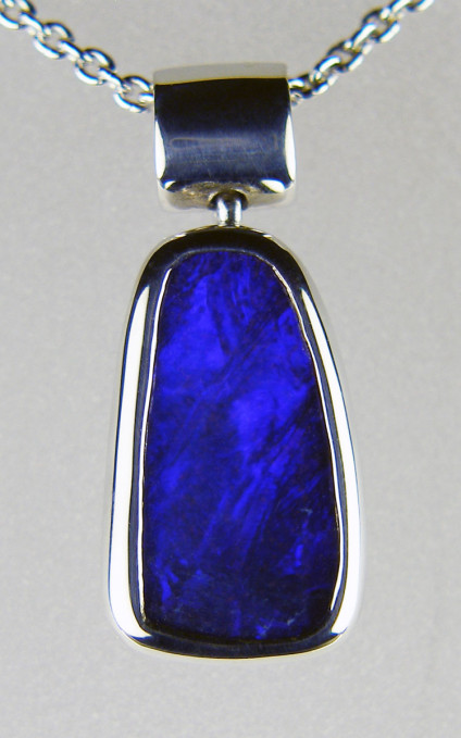 Boulder opal pendant in silver - Dainty boulder opal pendant in silver. Set with a deep purplish blue boulder opal from Queensland, Australia. Pendant 9 x 16mm.
