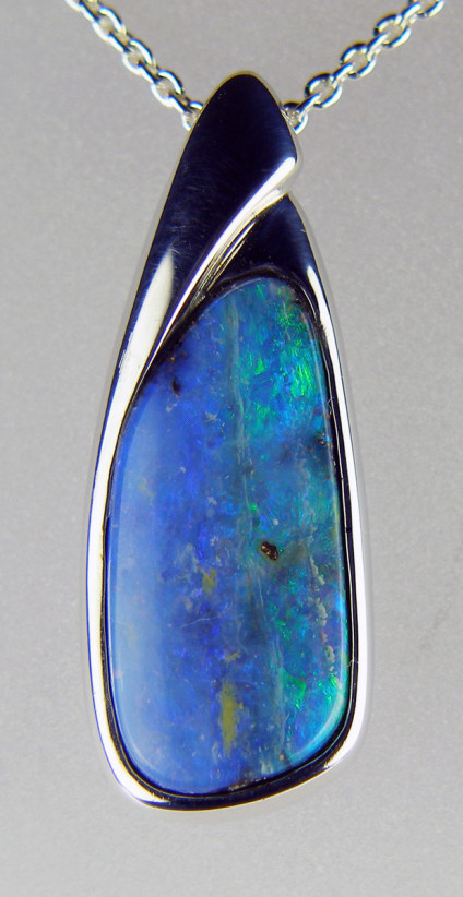 Boulder opal pendant in silver - Beautiful blue and turquoise green boulder opal from Queensland, Australia, set in silver pendant and suspended from a length adjustable silver chain. Pendant 30 x 13mm.
