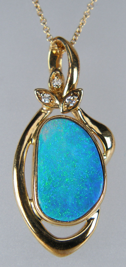 Opal doublet & diamond pendant in 14ct yellow gold - Pretty bright turquoise opal doublet rubover set in 14ct yellow gold with little diamond accents in the bail. Pendant is 15 x 30mm. Chain is not included.