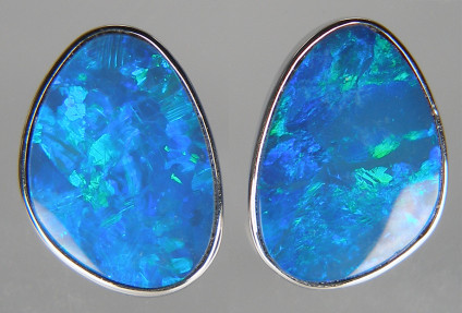 Opal doublet earrings in 14ct white gold - Matched pair of strongly blue green coloured opal doublets in 9ct white gold fine rubover set earstuds. Earstuds measure 11 x 15mm.