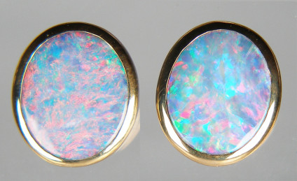 Opal doublet earrings in 9ct yellow gold - Oval pair of matched doublet opals in fine rubover set earstuds. Earstuds are 11 x 14mm.