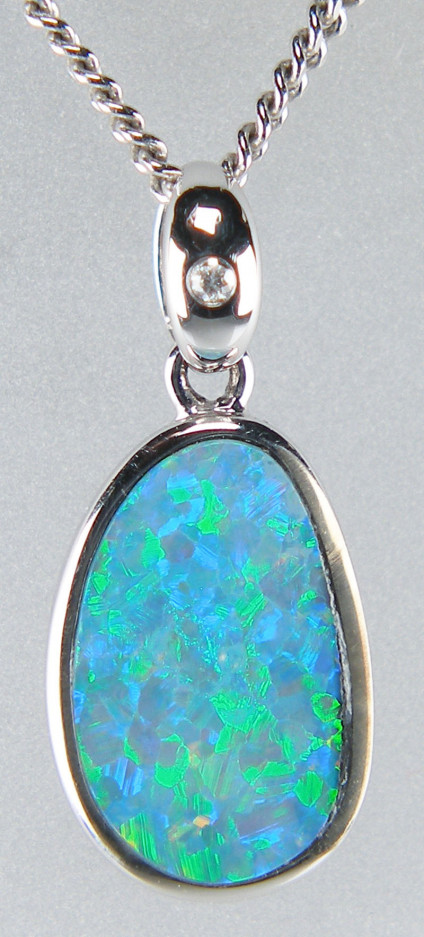 Opal doublet pendant with diamond in 18ct white gold - Dainty opal doublet set with a small diamond accent in 18ct white gold pendant measuring 9 x 19mm. Chain not included.