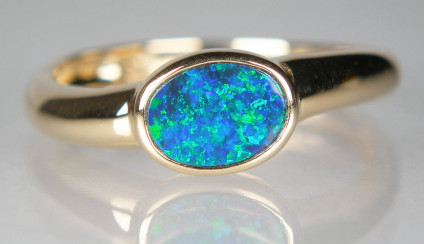 Opal doublet ring in 14ct yellow gold - bright blue/green opal doublet rubover set in 15ct yellow gold ring
