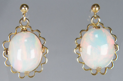 Opal eardrops in 9ct yellow gold - Attractive white opal oval cabochons with good red play of colour, set in 9ct yellow gold vintage mounts. These earrings are pre-loved. Earrings are 23 x 14mm.