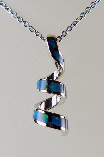 Silver spiral pendant set with inlaid black opal - Pretty silver pendant inlaid with Australian solid black opal. The pendant has been rhodium plated to resist tarnishing and is suspended from a rhodium plated silver chain of adjustable length 15-22".