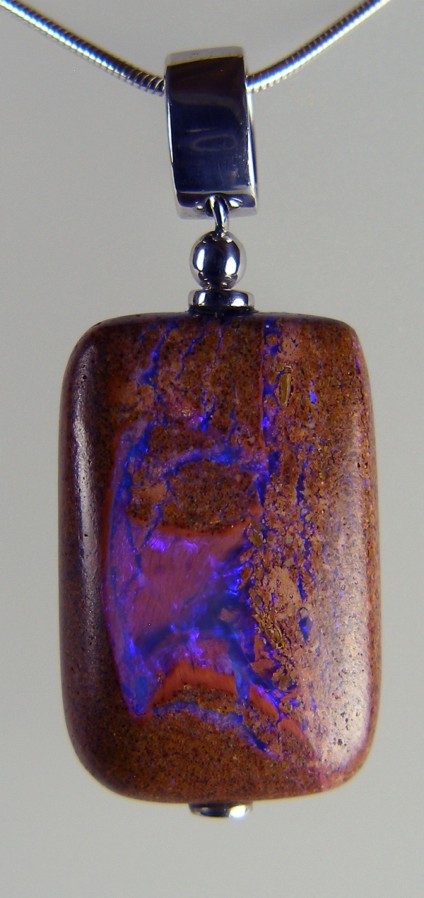Opalised wood in sandstone pendant - Rectangular opalised wood in sandstone pendant. This type of opal is very rare. Pendant is 5cm long by 2cm wide.  