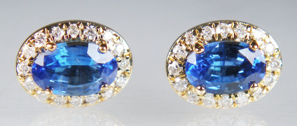 Oval sapphire & diamond earstuds in 9ct yellow gold - 0.76ct oval pair of beautiful blue sapphires, halo set with 0.12ct of round brilliant cut diamonds, in pretty earstuds in 9ct yellow gold. Earstuds are 8x6mm.
