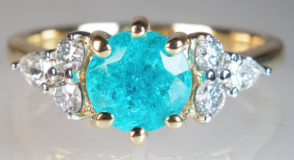 Paraiba tourmaline & diamond ring in 18ct yellow gold - Top quality, vibrant coloured, Brazilian Paraiba tourmaline (fully authenticated), claw set with 0.41ct of G colour VS clarity round and pear cut diamonds. The diamonds are mounted in white gold, the tourmaline and ring are all in 18ct yellow gold. This exquisite ring, which has been carefully designed to provide maximum protection to this exceptionally rare tourmaline, is made wedfit. 