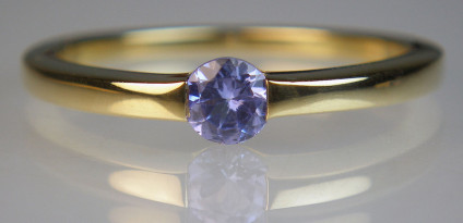 Tanzanite ring in 9ct yellow gold - Simple ring in 9ct yellow gold set with a single round cut tanzanite. Tanzanite is a soft gemstone and should be worn with care.